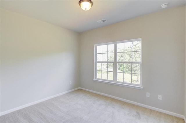 carpeted spare room with plenty of natural light