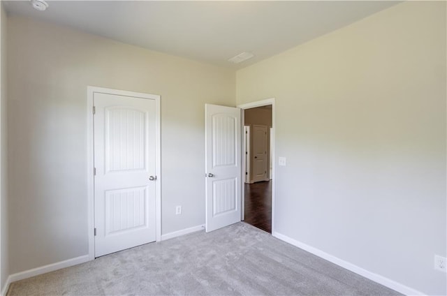 unfurnished bedroom featuring light colored carpet