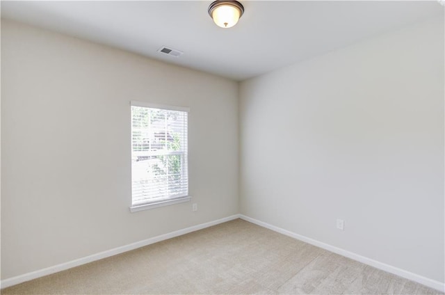 empty room featuring light carpet