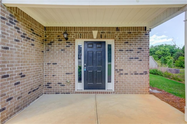 entrance to property with a patio