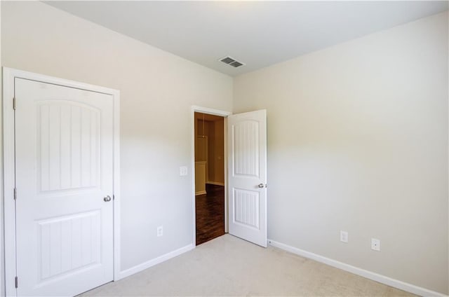 unfurnished bedroom featuring light carpet