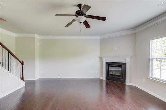 unfurnished living room featuring ornamental molding, a healthy amount of sunlight, and dark hardwood / wood-style floors