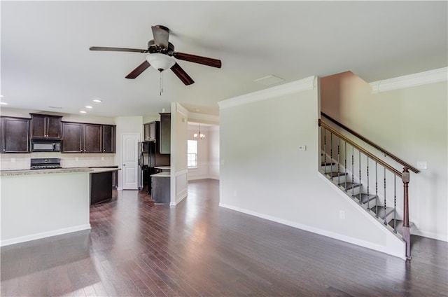 kitchen featuring black appliances, dark wood-type flooring, decorative backsplash, dark brown cabinets, and ceiling fan with notable chandelier