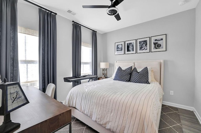 bedroom with a ceiling fan, visible vents, and baseboards