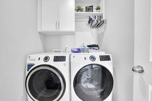 laundry room with cabinet space and washing machine and dryer