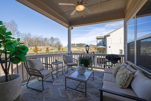 balcony with a sunroom, ceiling fan, an outdoor living space, and grilling area