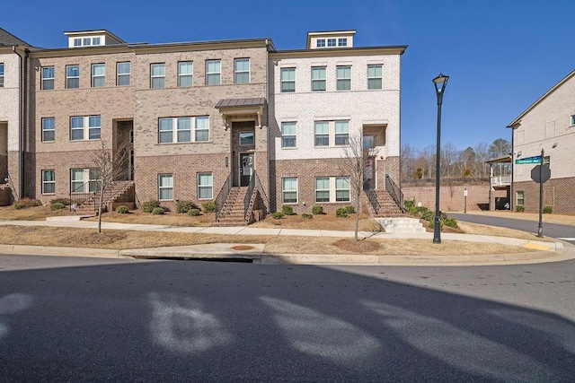 townhome / multi-family property featuring brick siding