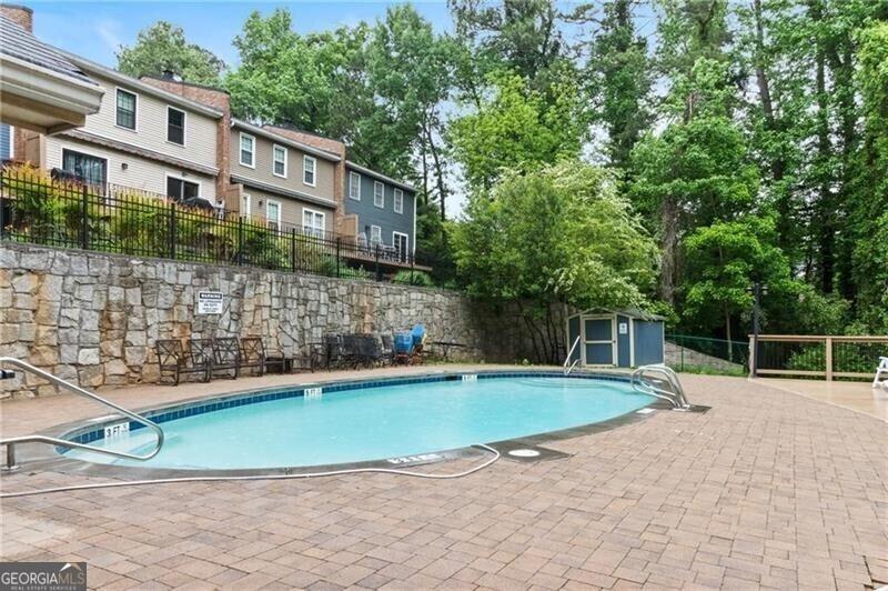 view of pool featuring a storage unit and a patio