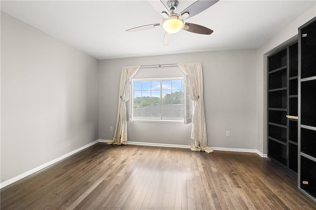 spare room with wood-type flooring and ceiling fan