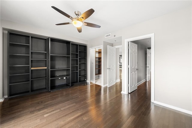 unfurnished bedroom featuring ceiling fan and dark hardwood / wood-style flooring