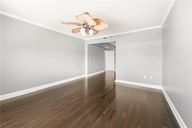 empty room featuring dark hardwood / wood-style floors, ceiling fan, and crown molding