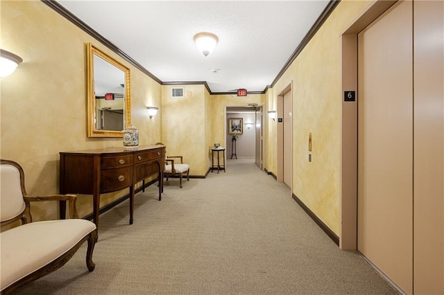 hallway featuring ornamental molding, light carpet, and elevator