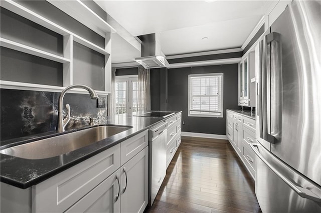 kitchen with stainless steel appliances, a healthy amount of sunlight, sink, wall chimney range hood, and white cabinetry