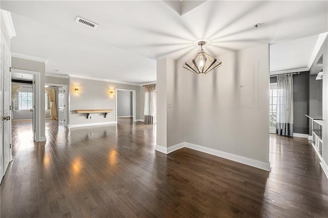 spare room with dark hardwood / wood-style flooring, an inviting chandelier, and ornamental molding