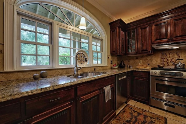 kitchen featuring appliances with stainless steel finishes, light stone counters, backsplash, sink, and ornamental molding