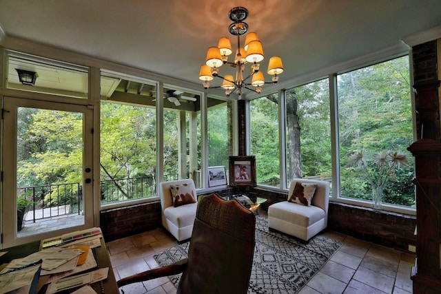 sunroom / solarium with plenty of natural light and ceiling fan with notable chandelier