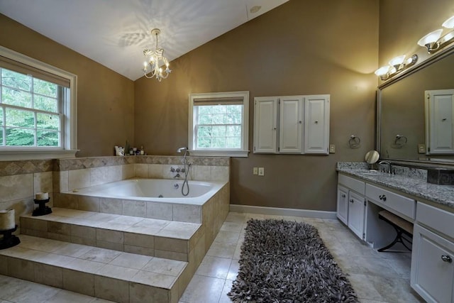 bathroom featuring vanity, lofted ceiling, a notable chandelier, tile floors, and tiled bath