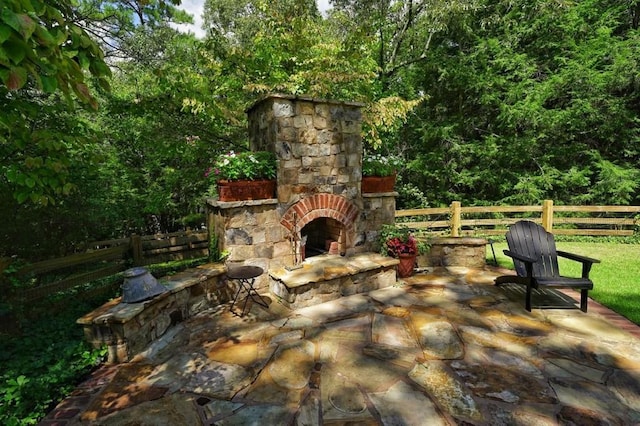 view of patio with an outdoor stone fireplace