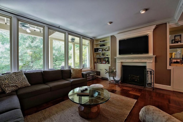 living room with dark parquet flooring, ornamental molding, and built in shelves