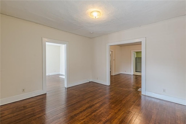 unfurnished room with dark hardwood / wood-style floors and a textured ceiling