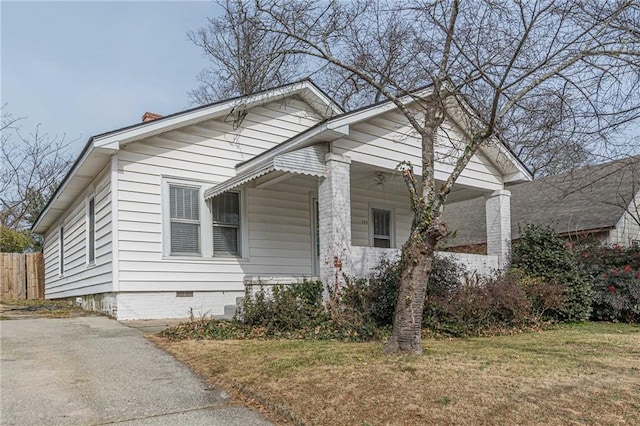 view of side of home with a yard