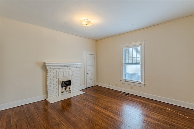 unfurnished living room featuring dark hardwood / wood-style floors and a fireplace