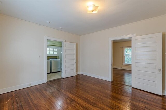 empty room featuring dark hardwood / wood-style flooring and plenty of natural light