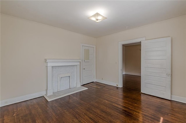 unfurnished living room with dark wood-type flooring and a fireplace