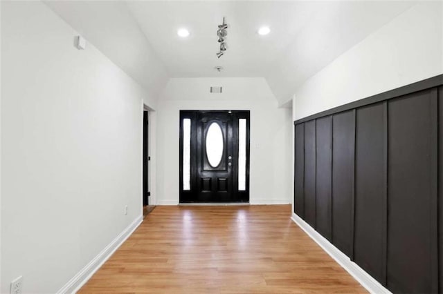 foyer entrance with lofted ceiling and light wood-type flooring