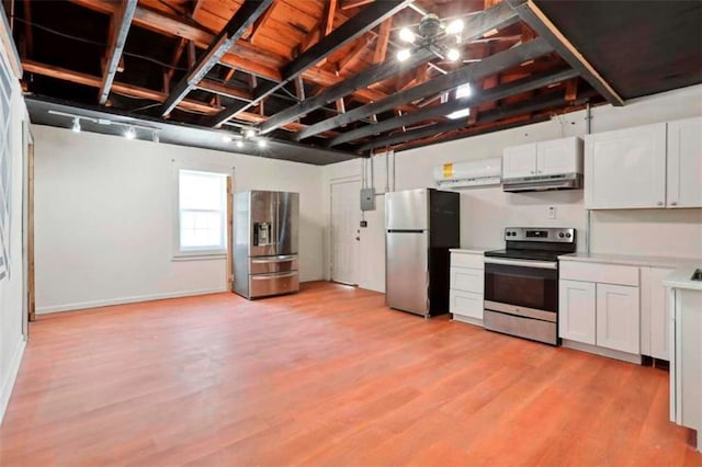 kitchen featuring white cabinets, light wood-type flooring, stainless steel appliances, and track lighting