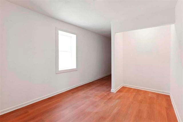 empty room featuring wood-type flooring