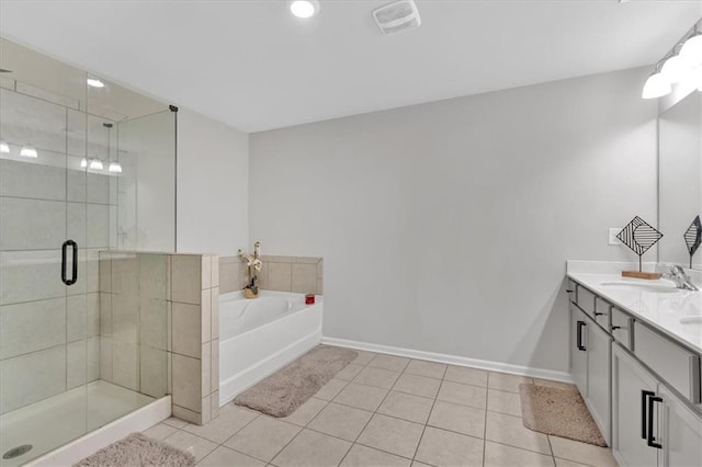 bathroom featuring tile patterned floors, shower with separate bathtub, and vanity