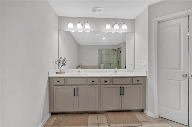 bathroom with vanity, an enclosed shower, and tile patterned floors