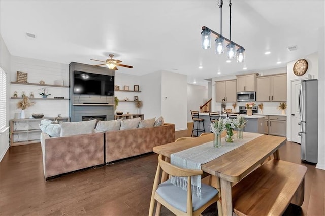 dining room with ceiling fan and dark hardwood / wood-style flooring