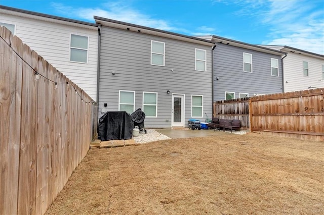 back of house with a patio area and a lawn