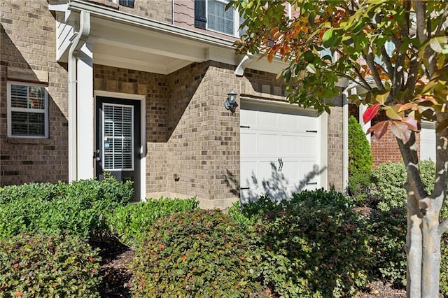 view of exterior entry featuring brick siding