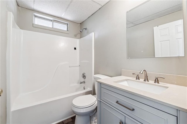 full bath featuring vanity, bathing tub / shower combination, toilet, and a paneled ceiling