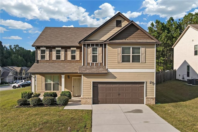 craftsman-style home featuring a front yard, a garage, and central AC unit