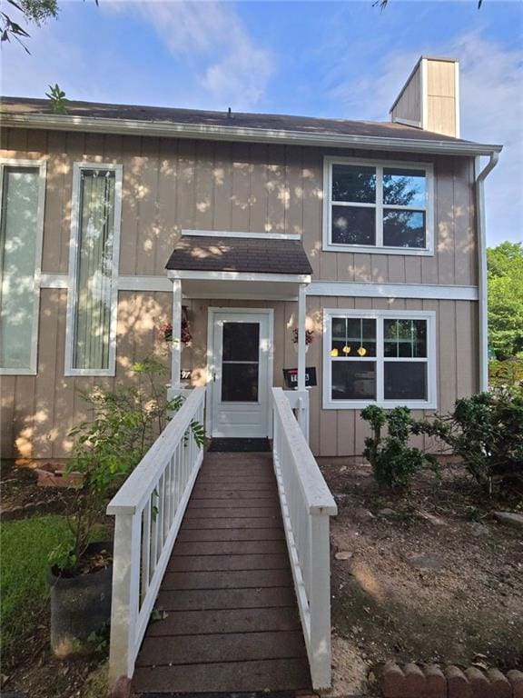 1297 Tree Creek Ct, Clarkston, GA 30021 - view of front facade featuring a chimney and board and batten siding