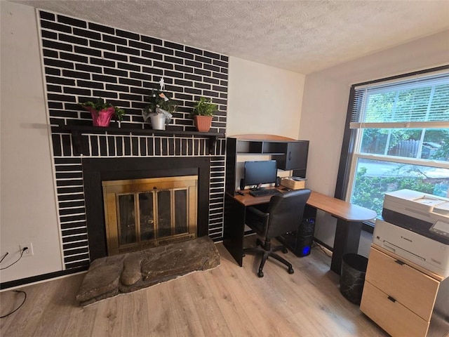 1297 Tree Creek Ct, Clarkston, GA 30021 - office space with a fireplace, wood finished floors, and a textured ceiling