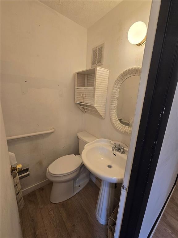 1297 Tree Creek Ct, Clarkston, GA 30021 - bathroom with wood finished floors and a textured ceiling