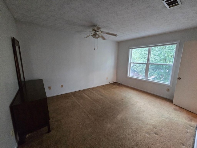 1297 Tree Creek Ct, Clarkston, GA 30021 - spare room featuring a ceiling fan, carpet flooring, and a textured ceiling