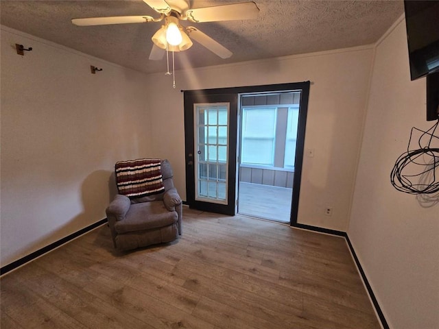 1297 Tree Creek Ct, Clarkston, GA 30021 - unfurnished room featuring a textured ceiling, wood finished floors, ceiling fan, and crown molding