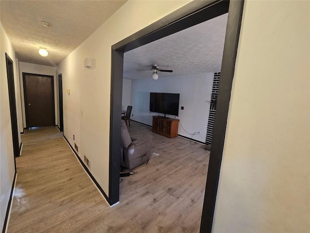 1297 Tree Creek Ct, Clarkston, GA 30021 - hallway featuring a textured ceiling and light wood finished floors