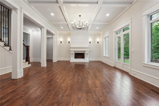 unfurnished living room featuring coffered ceiling, beam ceiling, a fireplace, and dark wood-type flooring