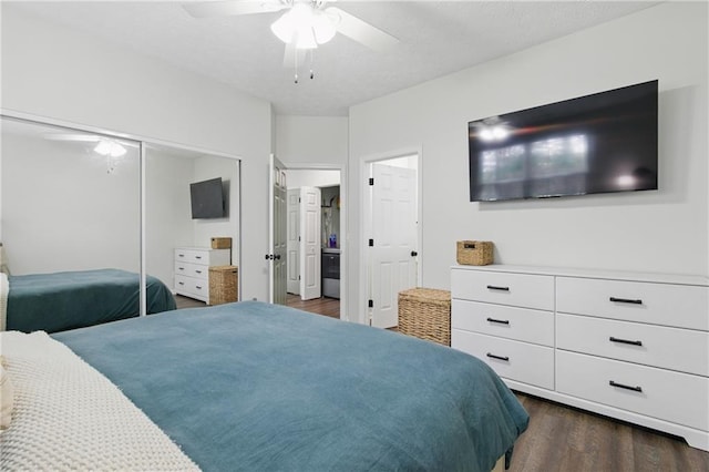 bedroom with a closet, a textured ceiling, ceiling fan, and dark wood-style flooring