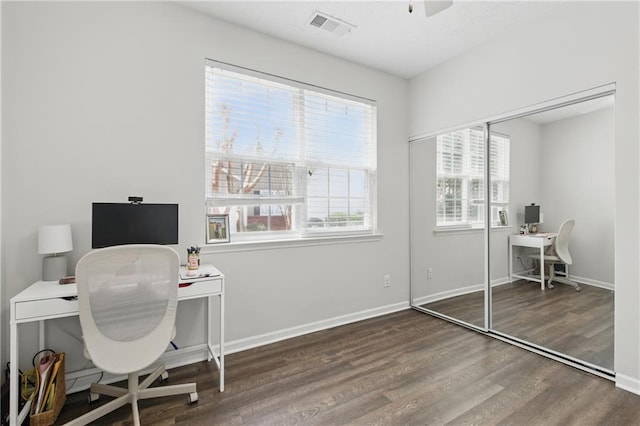 office featuring a ceiling fan, wood finished floors, visible vents, and baseboards