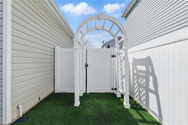 exterior space featuring fence and a gate