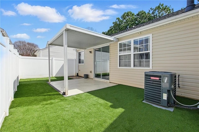 view of yard featuring central air condition unit, a fenced backyard, and a patio area