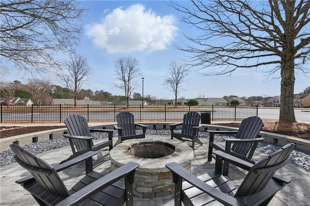 view of patio with a fire pit and fence